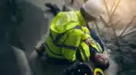 A WHS incident is an unplanned event at work that can cause harm. The image shows an event like this on a construction site - a worker is hurt.
