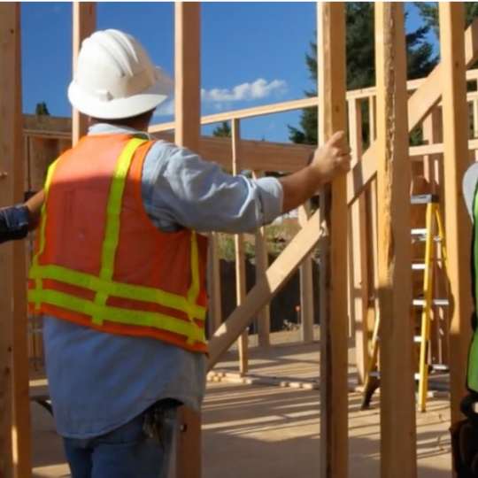 Construction worker lifting frame to show importance of construction induction training